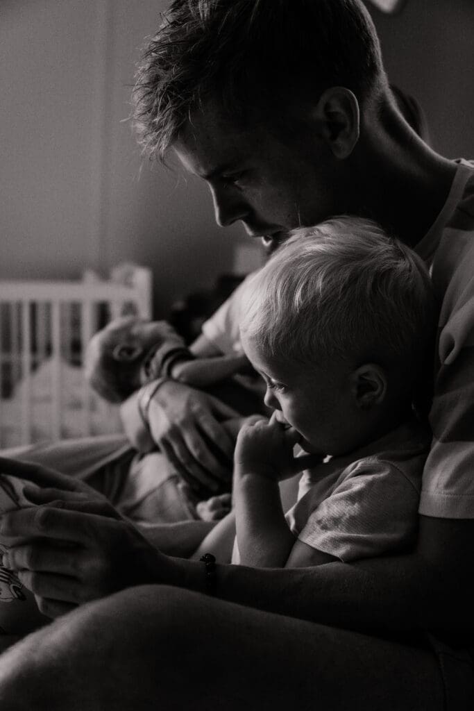 Rust en verbinding gevangen door een day in the life fotograaf tijdens een rustig zwart-wit moment van vader met zoon.
